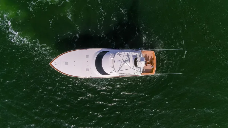 Slide: The Image of Aerial view of 2015 Viking 70 Convertible yacht cruising on green water. - 32