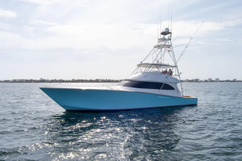 Slide: The Image of 2015 Viking 70 Convertible yacht cruising on open water. - 4