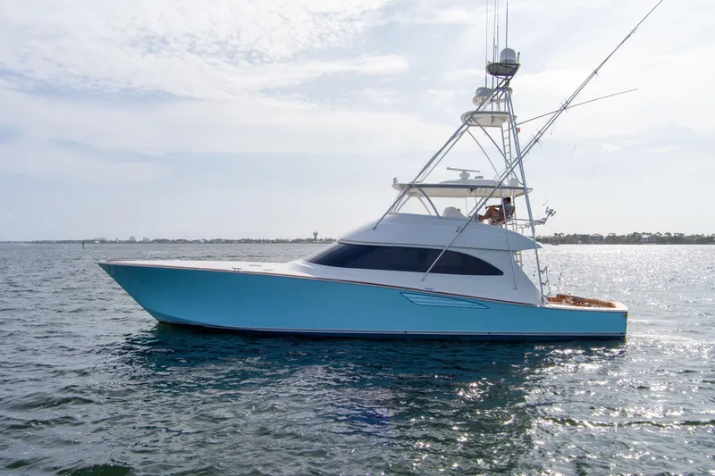 Slide: The Image of 2015 Viking 70 Convertible yacht on open water, side view. - 5