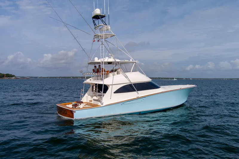 Slide: The Image of 2015 Viking 70 Convertible yacht on open water under blue sky. - 7