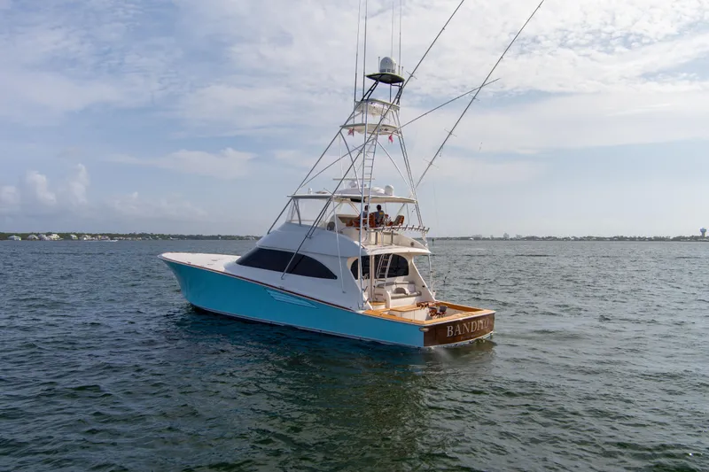 Slide: The Image of 2015 Viking 70 Convertible yacht on open water under a clear sky. - 9