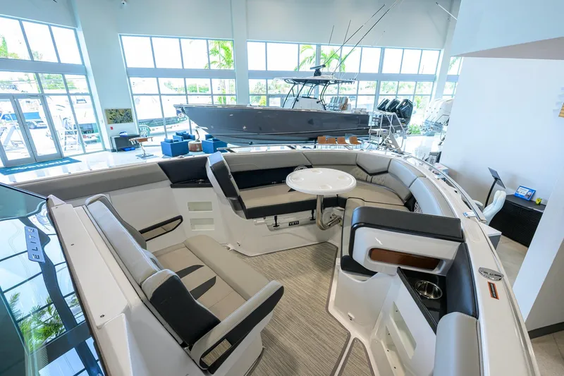 Slide: The Image of Luxurious interior of 2026 Monterey Elite 30 OB boat with spacious seating and table. - 18
