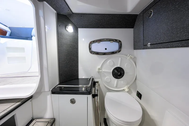 Slide: The Image of Luxurious bathroom interior of 2026 Monterey Elite 30 OB boat, featuring modern fixtures and sleek design. - 24