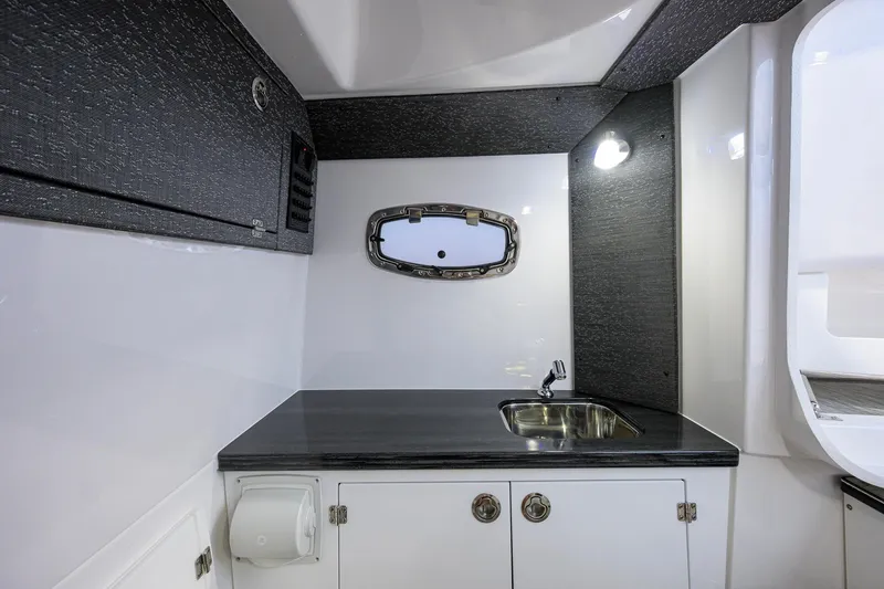 Slide: The Image of 2026 Monterey Elite 30 OB boat interior with sleek kitchenette and modern sink design. - 25