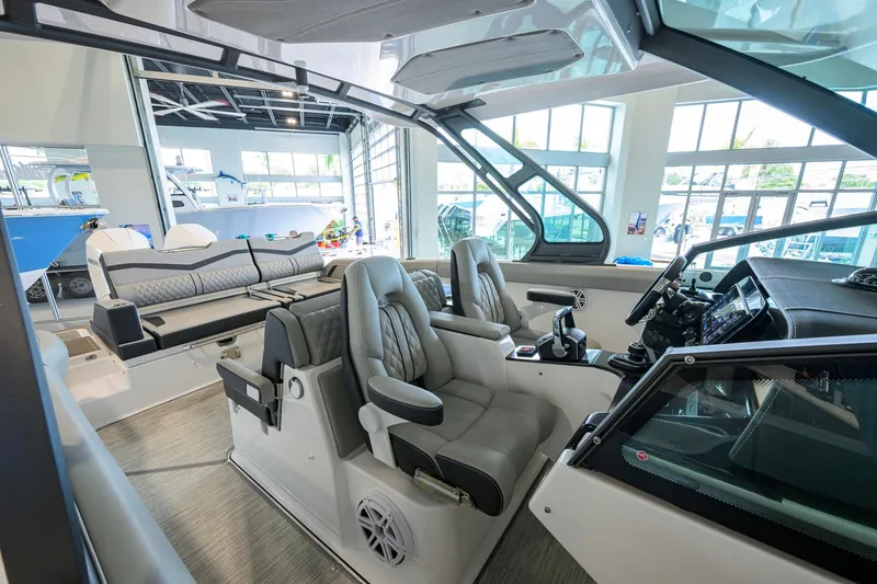 Slide: The Image of Interior of 2026 Monterey Elite 30 OB boat with luxurious seating and modern controls. - 27