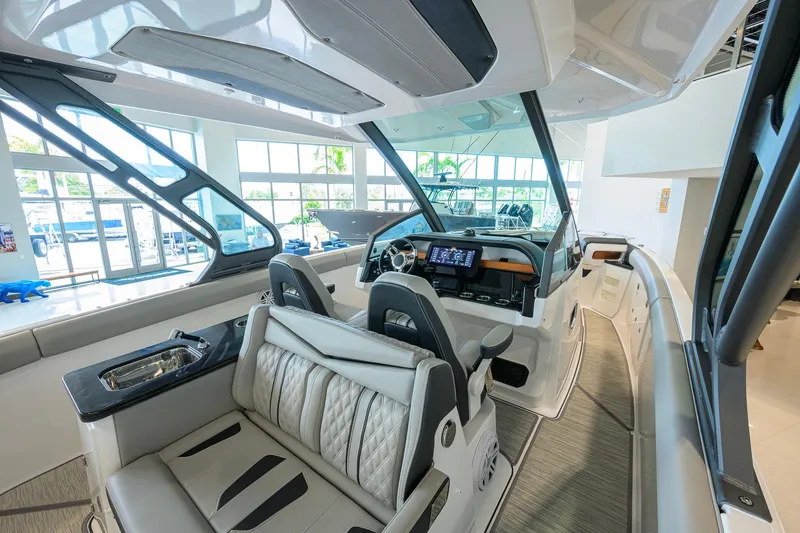 Slide: The Image of Luxurious interior of 2026 Monterey Elite 30 OB boat with modern dashboard and seating. - 28