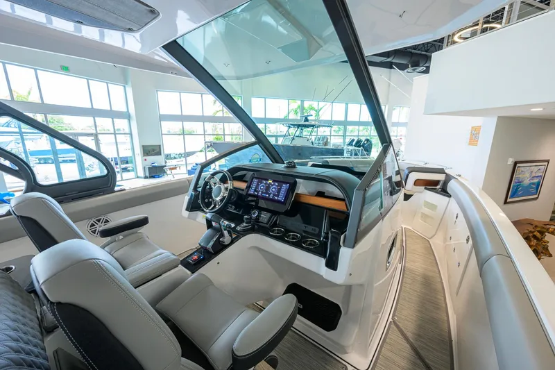Slide: The Image of Interior view of 2026 Monterey Elite 30 OB boat showcasing modern helm and seating. - 29