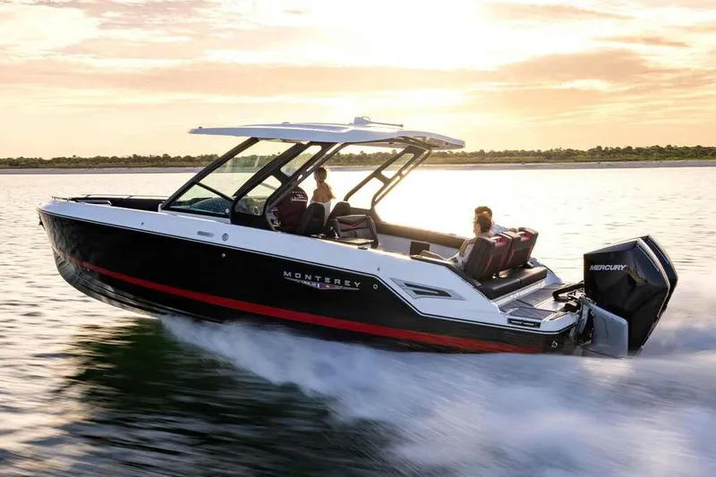 Slide: The Image of Manufacturer Provided Image: 2026 Monterey Elite 30 OB boat cruising on water at sunset. - 3