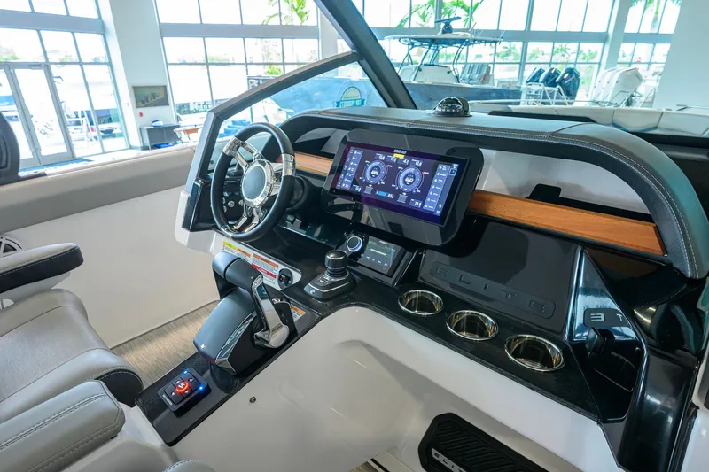 Slide: The Image of 2026 Monterey Elite 30 OB boat dashboard with modern controls and touchscreen display. - 30