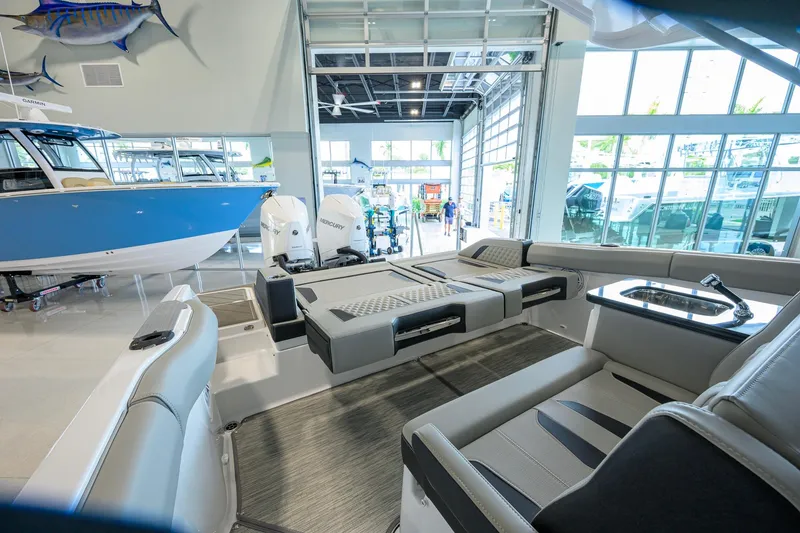 Slide: The Image of 2026 Monterey Elite 30 OB boat interior with luxurious seating and modern amenities in showroom. - 32