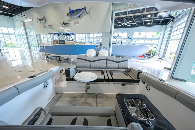 Slide: The Image of Interior view of a 2026 Monterey Elite 30 OB boat in a showroom. - 33