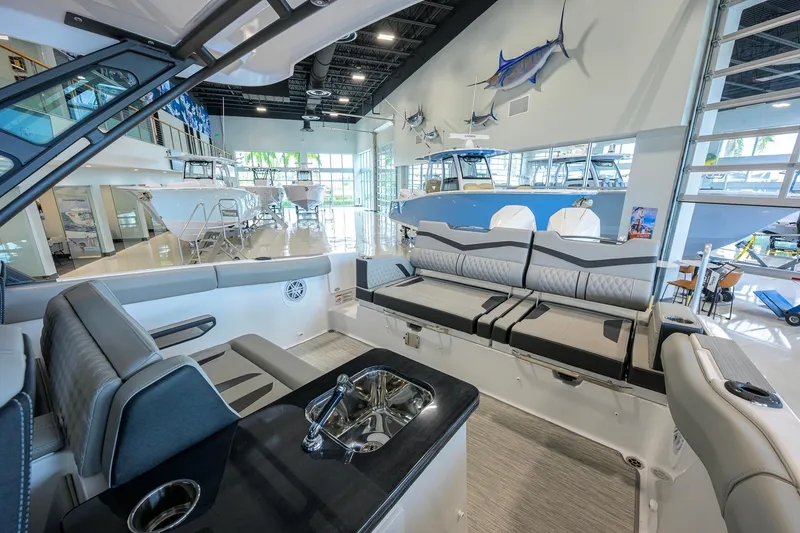Slide: The Image of Luxurious interior of 2026 Monterey Elite 30 OB boat in a showroom setting. - 35
