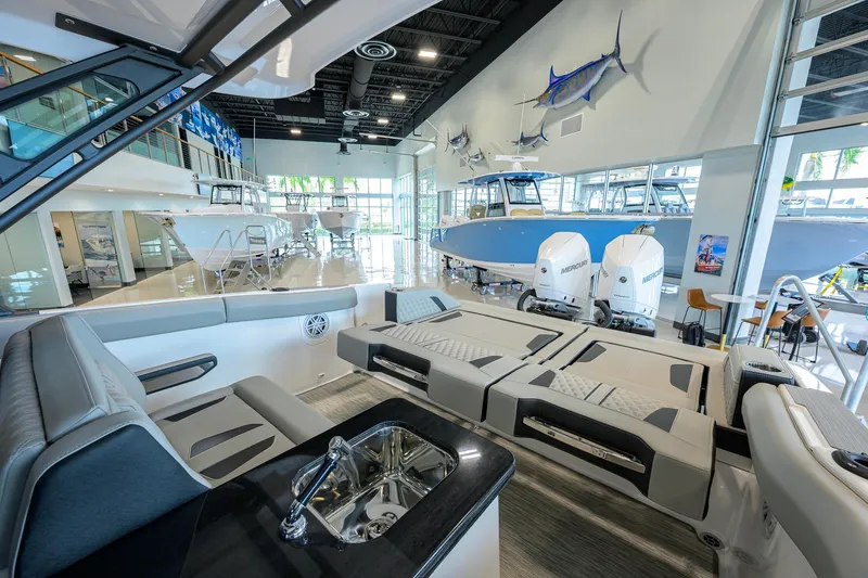Slide: The Image of Modern showroom displaying 2026 Monterey Elite 30 OB boats with luxurious interiors and powerful engines. - 36
