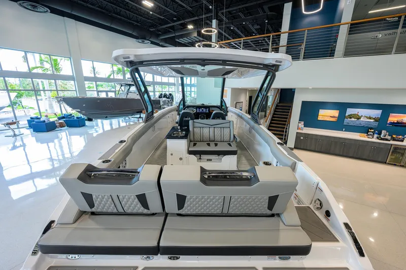 Slide: The Image of 2026 Monterey Elite 30 OB luxury boat interior in showroom, featuring sleek seating and modern design. - 42