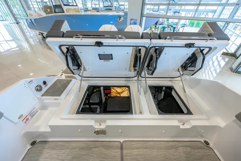 Slide: The Image of 2026 Monterey Elite 30 OB boat storage compartments open in showroom. - 43