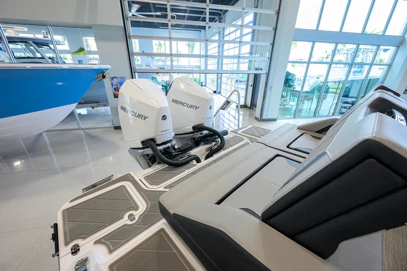 Slide: The Image of 2026 Monterey Elite 30 OB boat with dual Mercury outboard engines in showroom. - 44