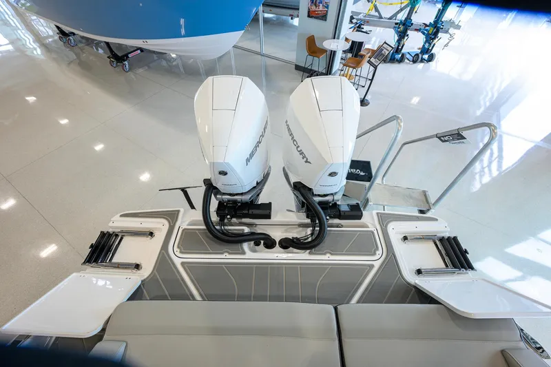 Slide: The Image of 2026 Monterey Elite 30 OB boat with dual Mercury outboard engines in showroom. - 45