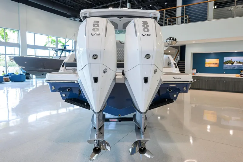 Slide: The Image of 2026 Monterey Elite 30 OB boat with dual 300 V8 engines in showroom. - 49