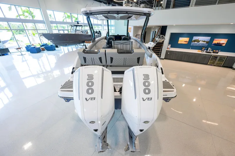 Slide: The Image of 2026 Monterey Elite 30 OB boat with dual Mercury 300 V8 engines in showroom. - 50