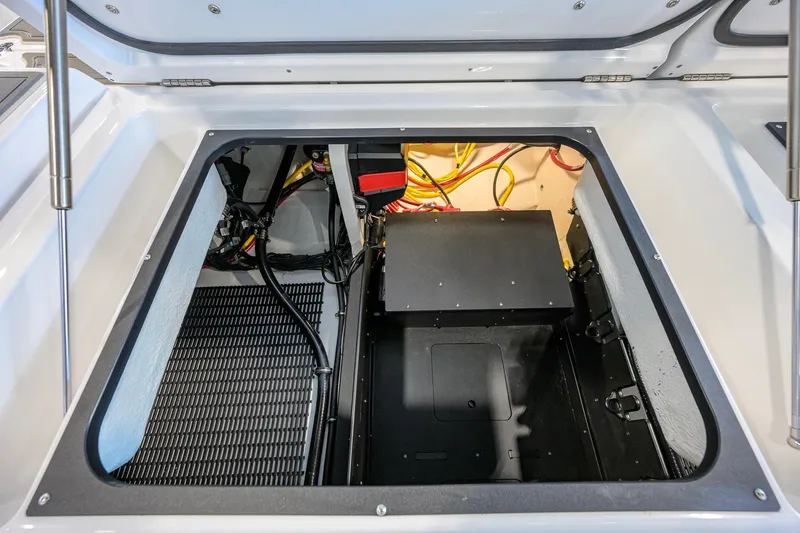 Slide: The Image of Open storage compartment of 2026 Monterey Elite 30 OB boat, showcasing wiring and components. - 51