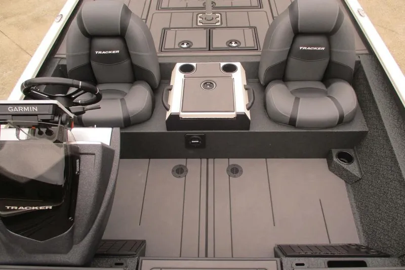 Slide: The Image of 2026 Tracker Savage 215 boat interior with dual seats, steering wheel, and Garmin navigation system. - 10