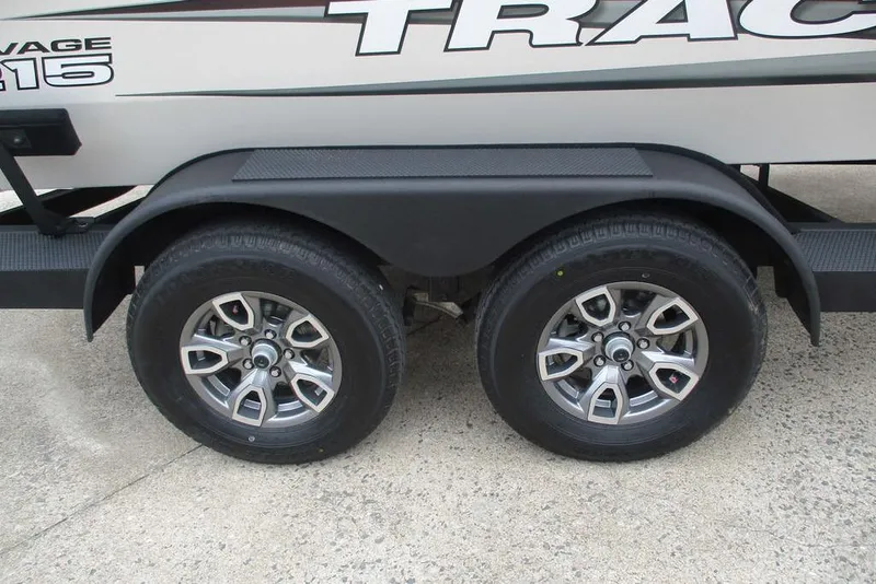Slide: The Image of Trailer wheels of a 2026 Tracker Savage 215 boat on concrete surface. - 13