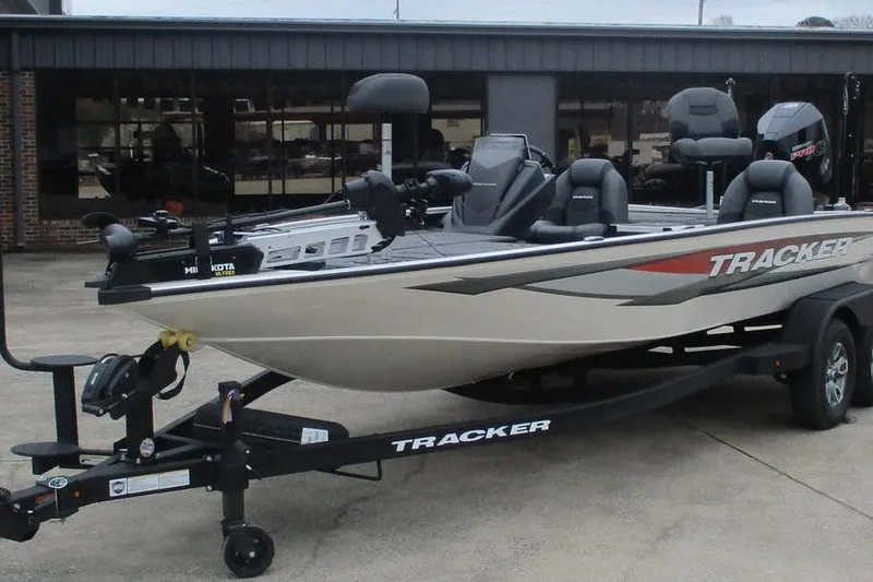 Slide: The Image of 2026 Tracker Savage 215 boat on trailer, parked outside a building. - 4