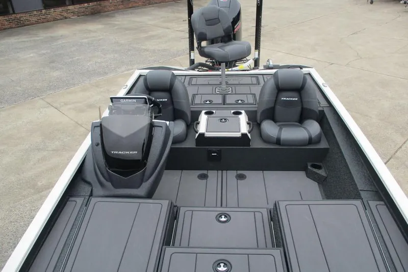 Slide: The Image of 2026 Tracker Savage 215 boat interior with seating and Garmin equipment. - 8