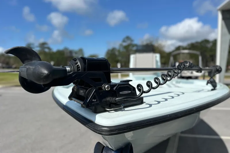 Slide: The Image of 2017 Yellowfin 24 Bay CE boat with trolling motor, parked outdoors under blue sky. - 13