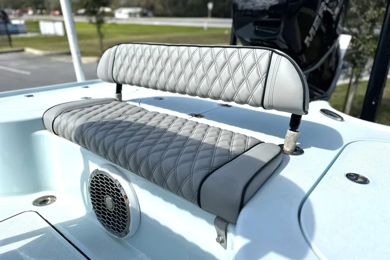 Slide: The Image of 2017 Yellowfin 24 Bay CE boat with quilted gray seating and speaker detail. - 4