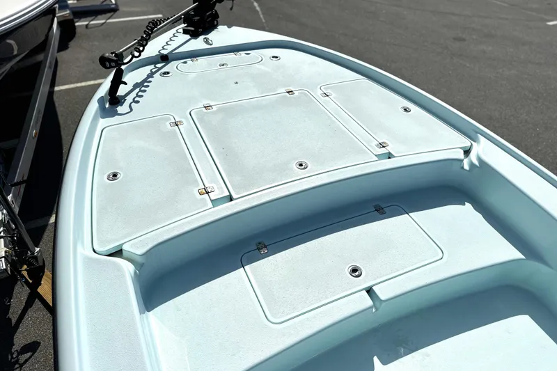 Slide: The Image of 2017 Yellowfin 24 Bay CE boat deck with storage compartments and trolling motor. - 6