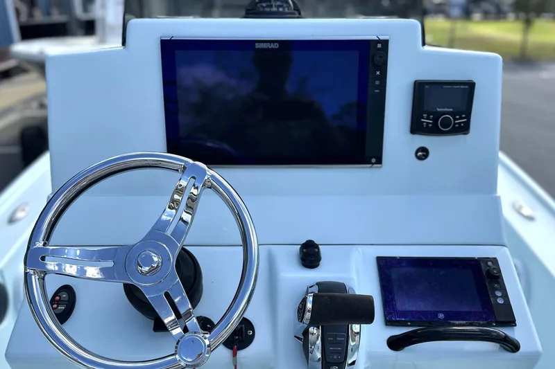 Slide: The Image of 2017 Yellowfin 24 Bay CE boat dashboard with steering wheel and navigation controls. - 7