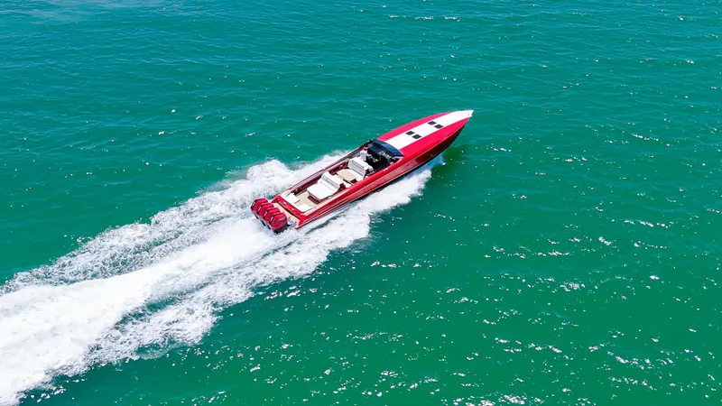 Slide: The Image of 2023 Nor-Tech 55 Flyer speedboat cruising on turquoise water. - 1