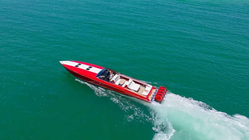 Slide: The Image of 2023 Nor-Tech 55 Flyer speedboat cruising on open water, aerial view. - 2