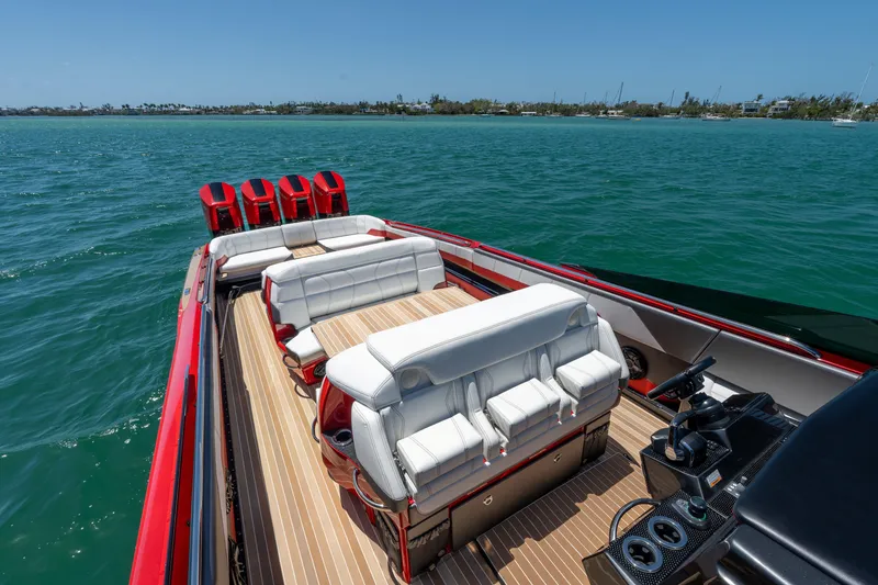 Slide: The Image of 2023 Nor-Tech 55 Flyer luxury boat with red accents on open water. - 32