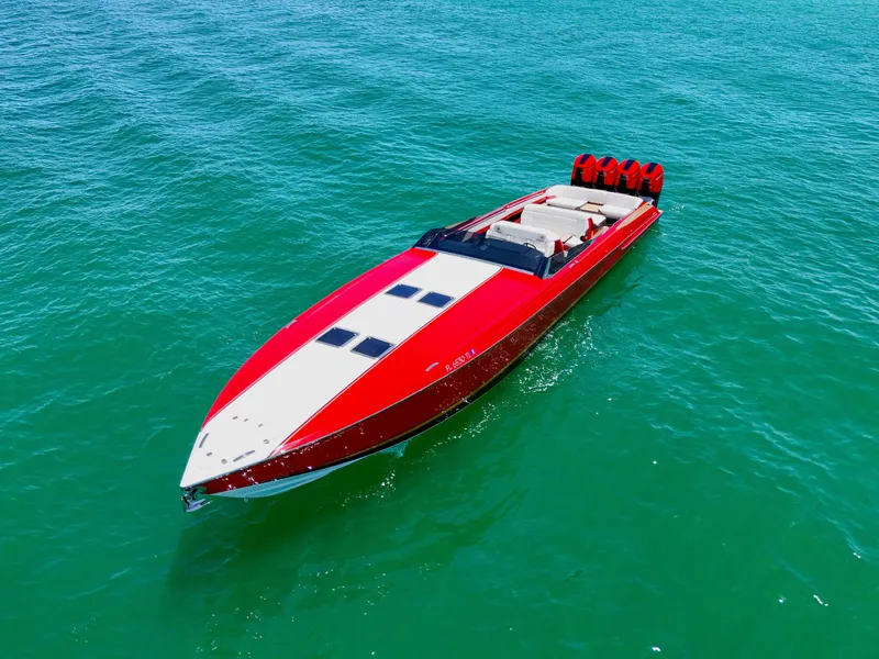 Slide: The Image of 2023 Nor-Tech 55 Flyer speedboat on clear blue water, showcasing sleek red design. - 5