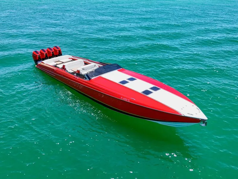 Slide: The Image of 2023 Nor-Tech 55 Flyer boat in vibrant red on clear blue water. - 6
