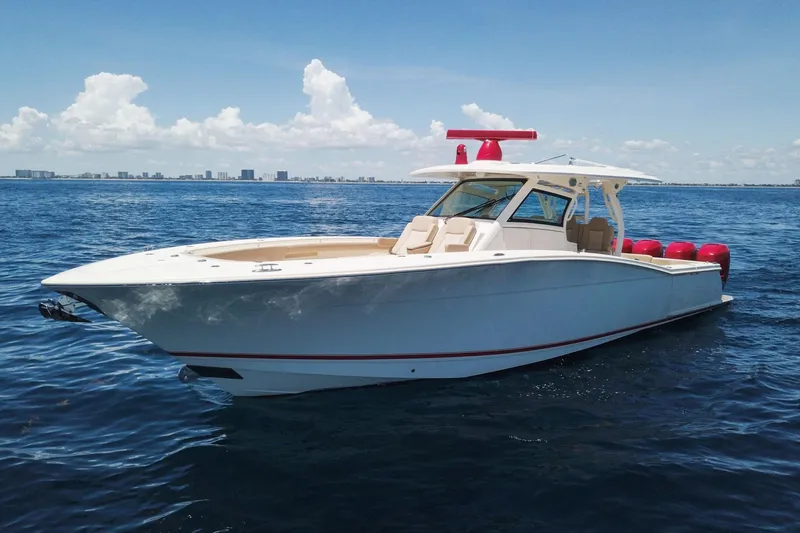 The Image of 2020 Scout 380 LXF boat on open water under clear blue sky. - 0