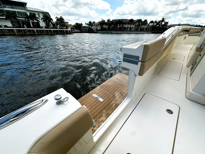 Slide: The Image of 2020 Scout 380 LXF boat deck with waterfront view and luxurious seating. - 10