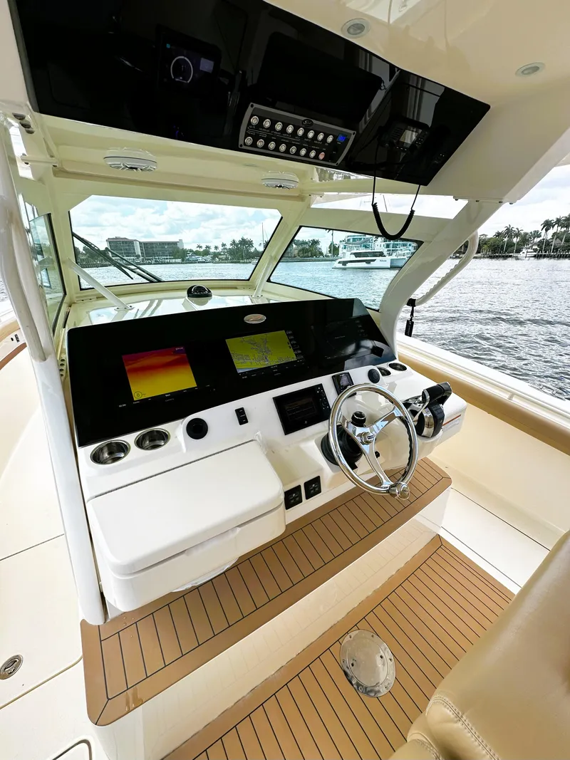Slide: The Image of 2020 Scout 380 LXF boat helm with advanced navigation system and luxurious interior. - 11