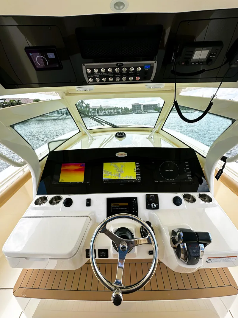Slide: The Image of 2020 Scout 380 LXF boat helm with advanced navigation displays and controls. - 12