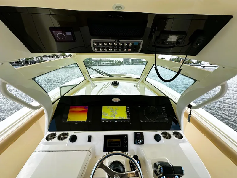 Slide: The Image of 2020 Scout 380 LXF boat dashboard with advanced navigation and control systems. - 13