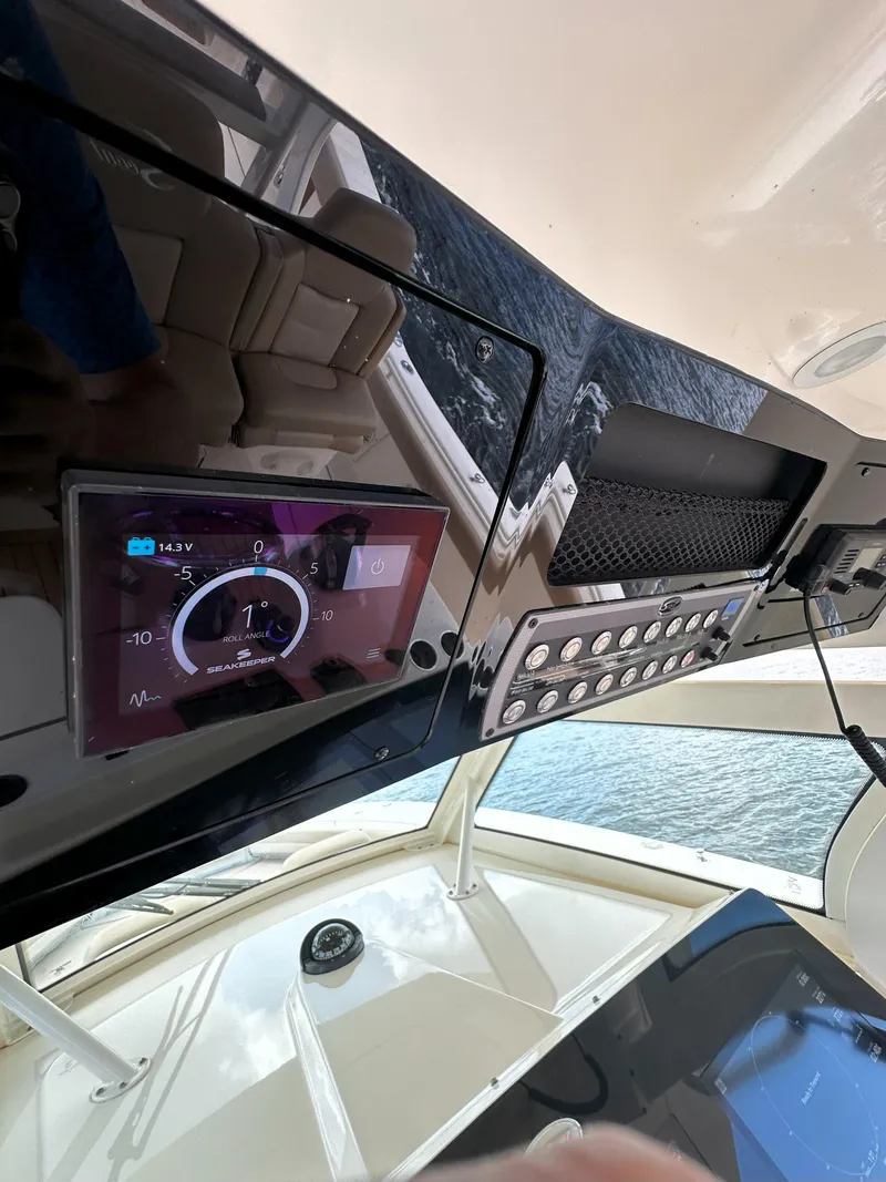 Slide: The Image of 2020 Scout 380 LXF boat dashboard with digital display and controls. - 16