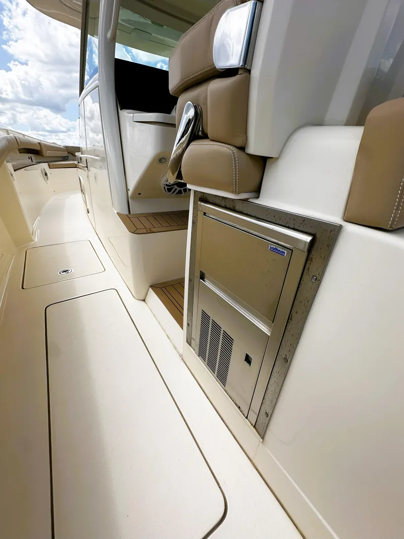 Slide: The Image of 2020 Scout 380 LXF boat interior with seating and built-in storage. - 17