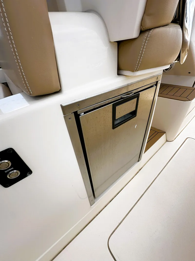 Slide: The Image of 2020 Scout 380 LXF boat interior with built-in stainless steel storage compartment. - 18