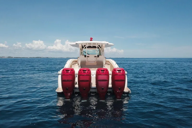 Slide: The Image of 2020 Scout 380 LXF boat with four red outboard engines on open sea. - 2