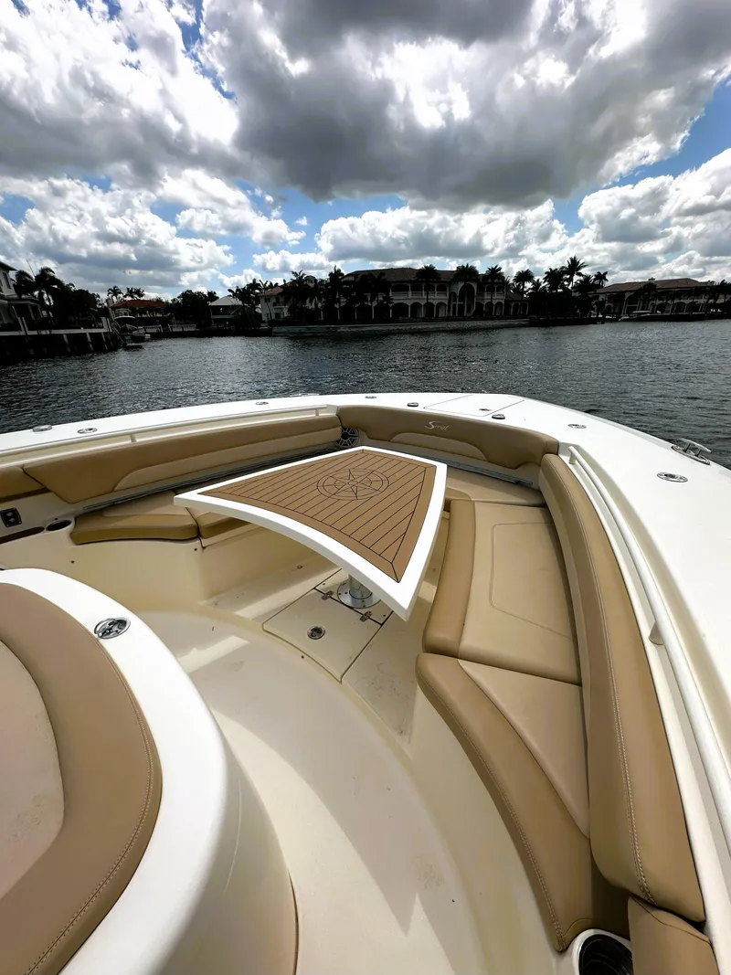 Slide: The Image of 2020 Scout 380 LXF boat with luxurious seating and table on a sunny day. - 22