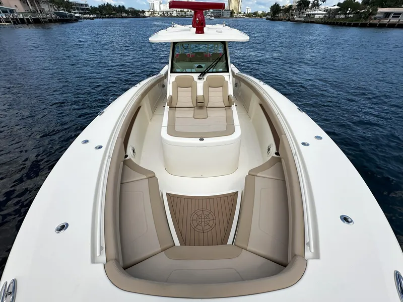 Slide: The Image of 2020 Scout 380 LXF boat on water, featuring spacious seating and elegant design. - 23