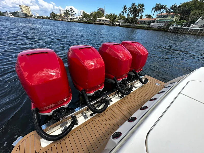 Slide: The Image of 2020 Scout 380 LXF boat with four red outboard engines on a sunny waterfront. - 24