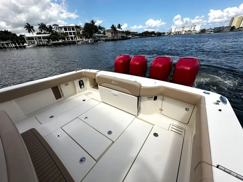 Slide: The Image of 2020 Scout 380 LXF boat with red engines on a scenic waterfront. - 4